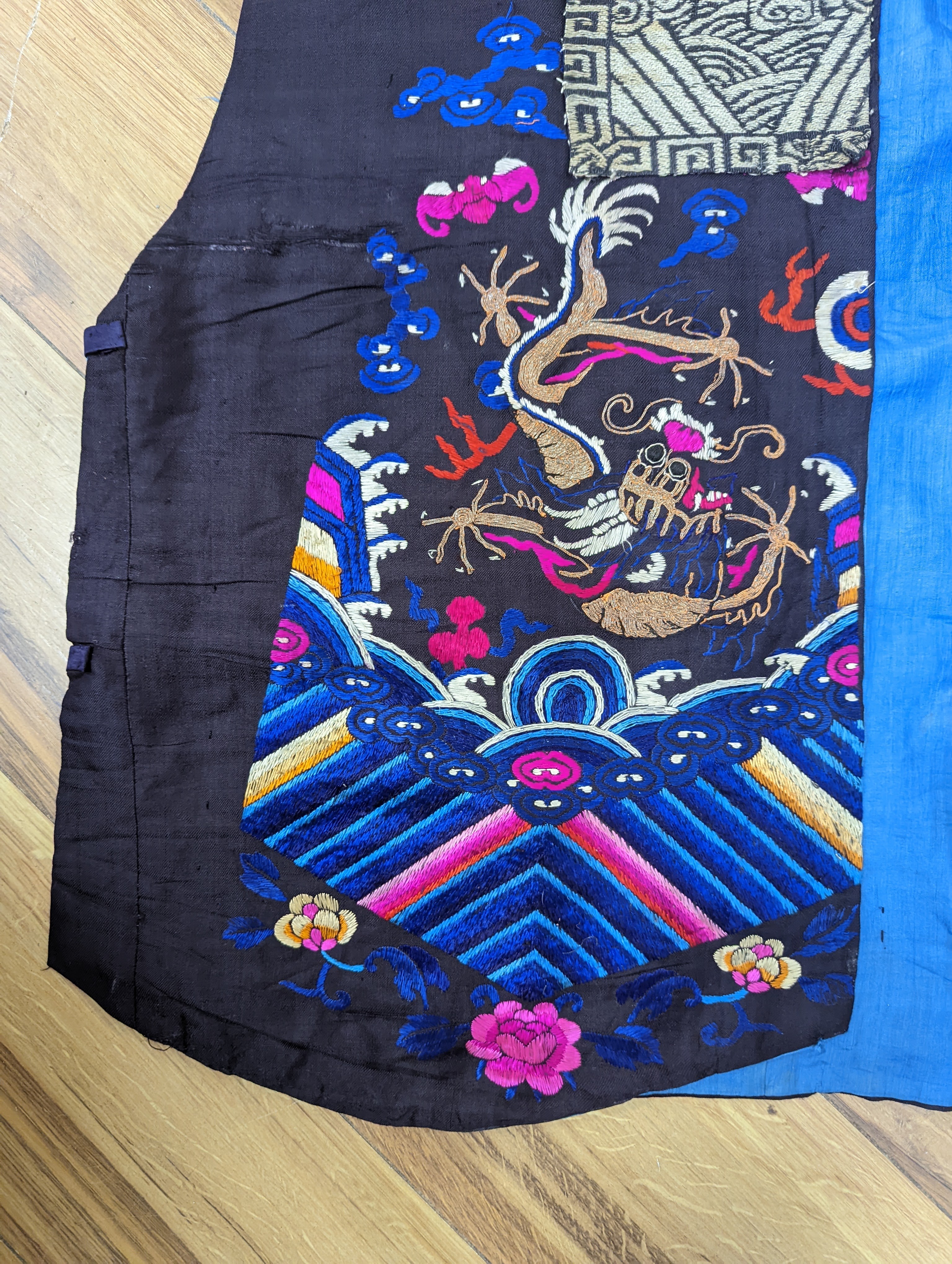 A 1920's Chinese dragon embroidered waistcoat, a cream silk drawn thread dress and a silk crepe black and patterned reversible kimono (3 items).